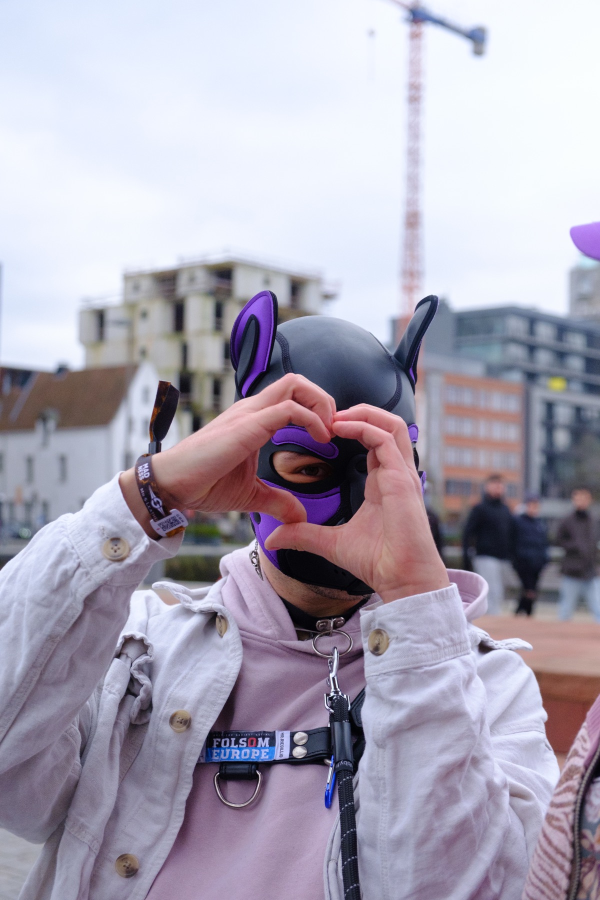 Fen making a heart with hands in pup hood